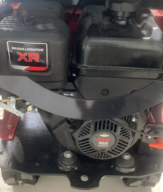 Black gas engine with Briggs & Stratton XR label and visible recoil starter on mini excavator component.