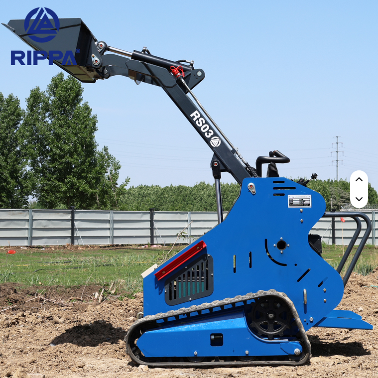 Blue Rippa RS03 skid steer with gas engine, compact tracked loader with raised bucket on dirt ground.
