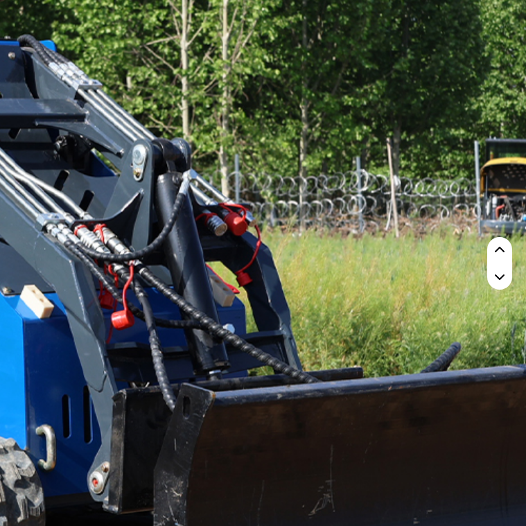 Compact blue Rippa RS03 skid steer with front bucket attachment in outdoor setting.