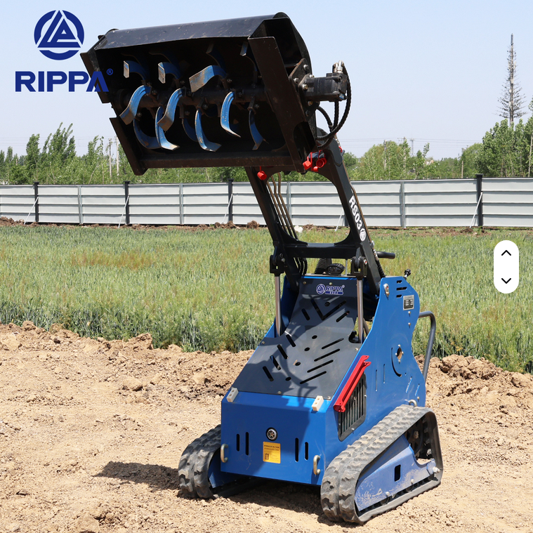Compact blue Rippa RS03 skid steer with tracked wheels and raised auger attachment on dirt ground.