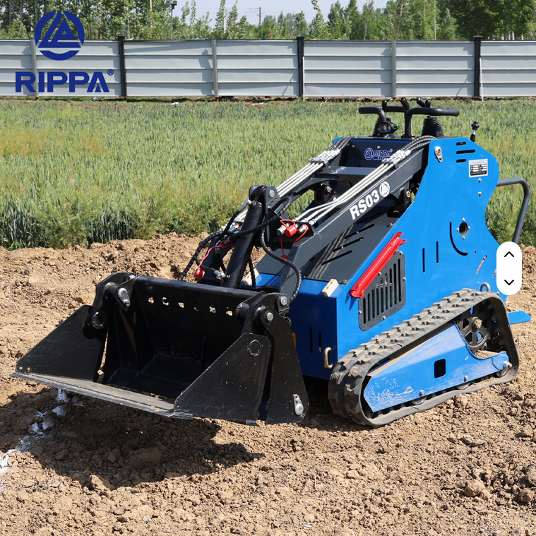 Blue Rippa RS03 skid steer with black bucket and rubber tracks on dirt terrain.