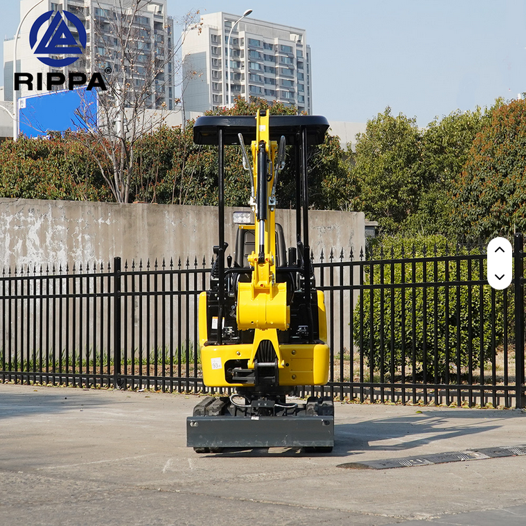 Compact yellow mini excavator with black hydraulic boom and quick coupler, parked on pavement.