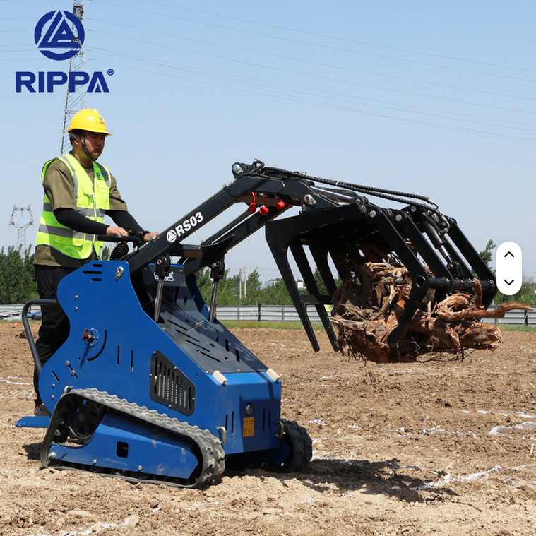 Blue Rippa RS03 gas skid steer with operator wearing safety vest and helmet lifting debris on dirt ground.