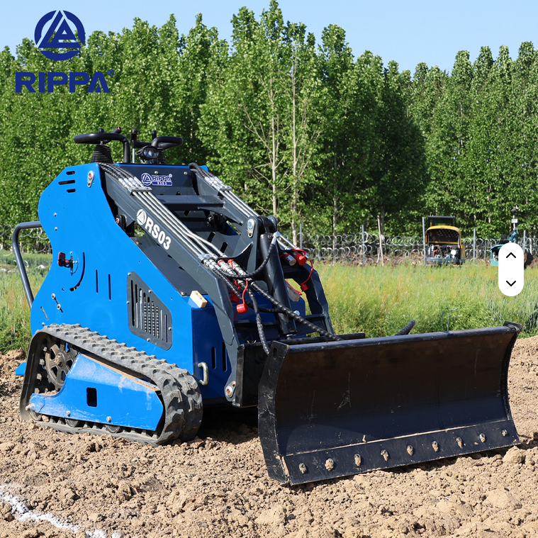 Blue Rippa RS03 skid steer with gas engine and steel blade on dirt surface outdoors.